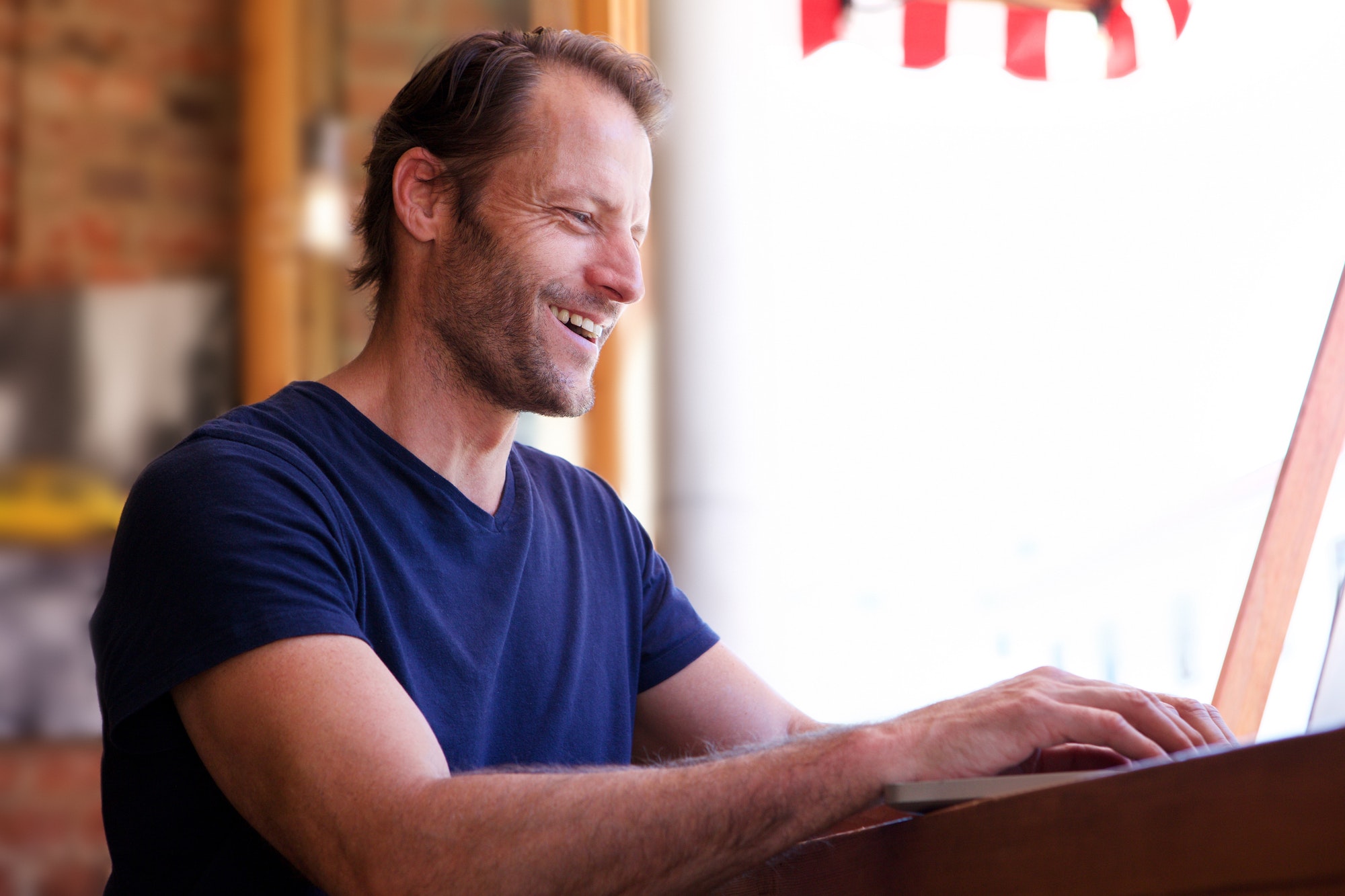 happy man working on laptop